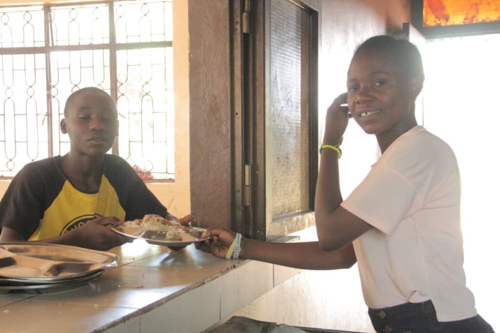 msamaria orphanage center matron serving food